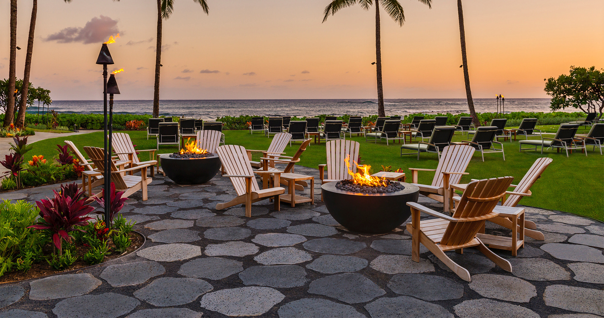 Firepits and chairs on the lawn by the ocean