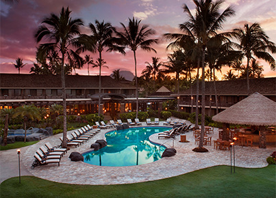 view of the resort and pool during sunset