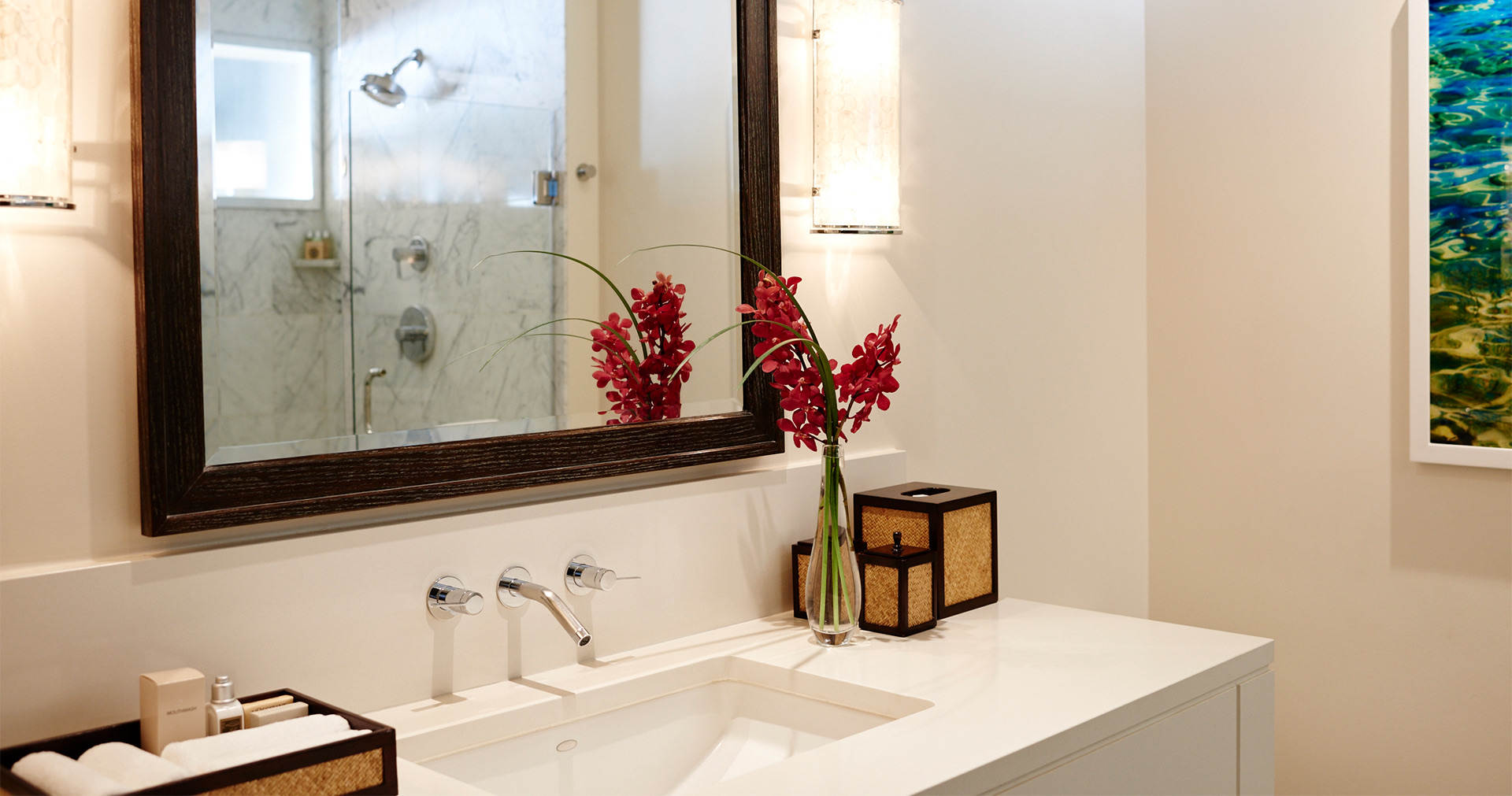 a bathroom sink with a large mirror and elegant decor