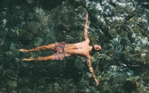 man floating in water