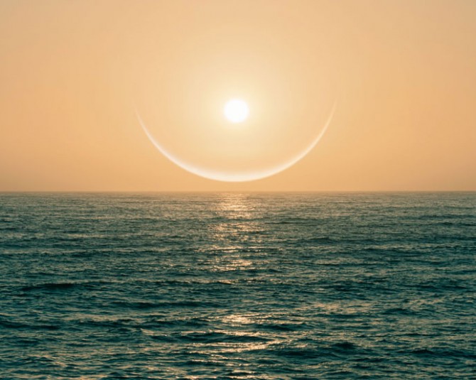 ring around sun during sunset over the ocean