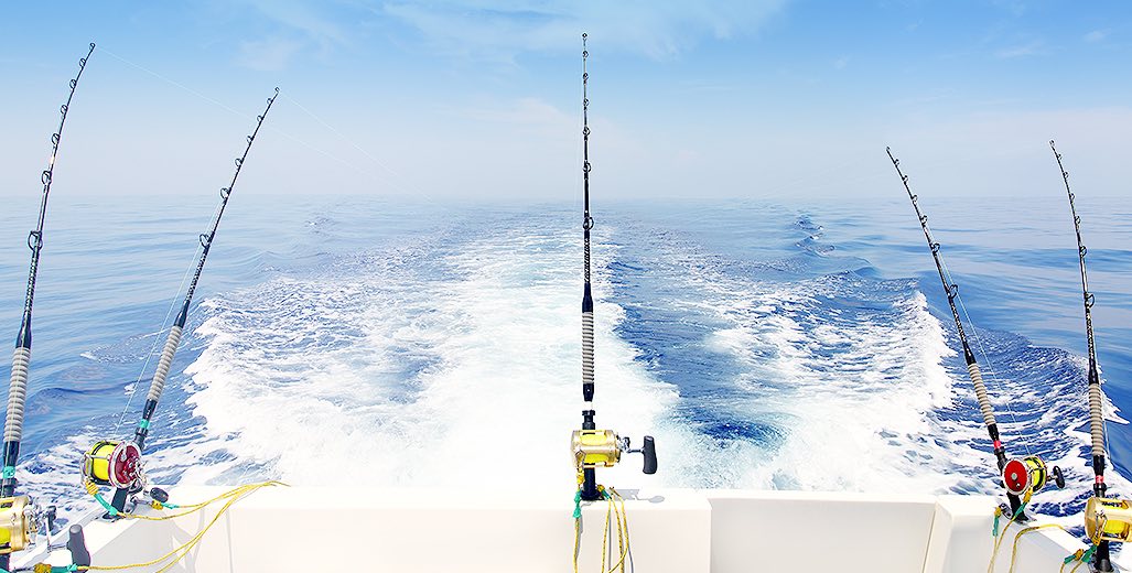 wake of a boat and fishing rods