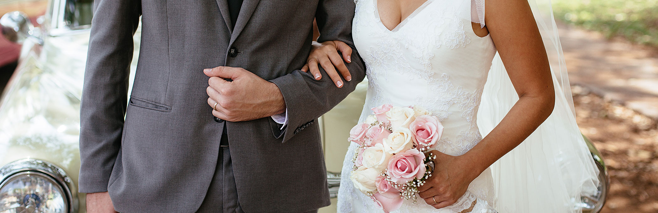couple interlocking arms at their wedding