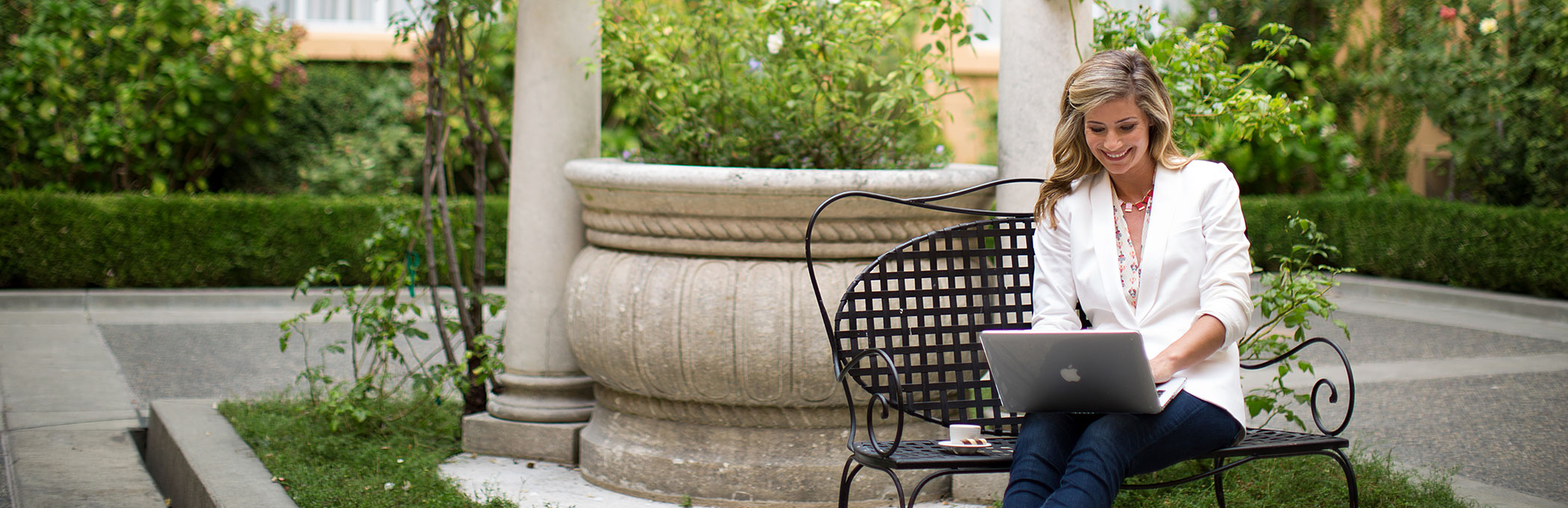 woman on macbook outdoors