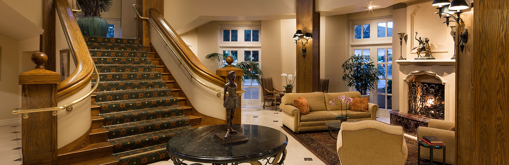 Lobby area with seating area couches next to staircase
