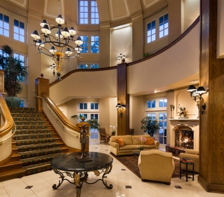 Lobby area with seating area couches next to staircase