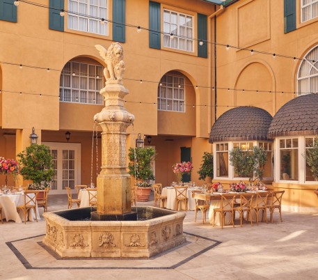 courtyard wedding with tables and chairs and fountain