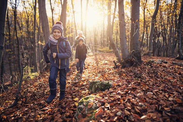 kids hiking in fall leaves