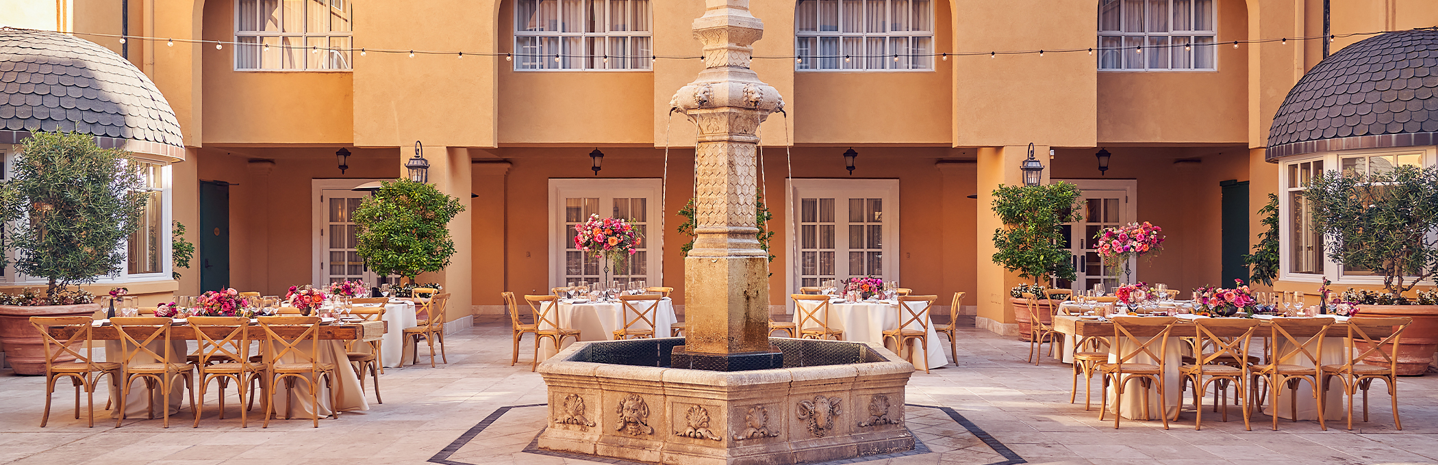 courtyard wedding with tables and chairs and fountain