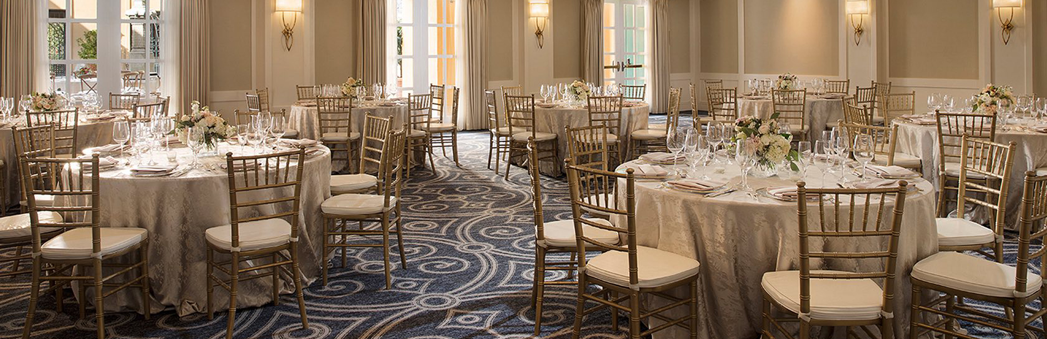 tables and chairs set up in a ballroom