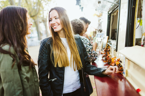 two girls at food truck in the fall