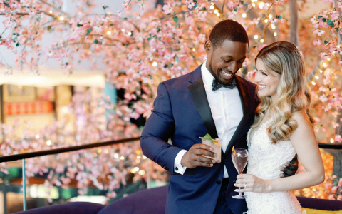 bride and groom around pink flower tree