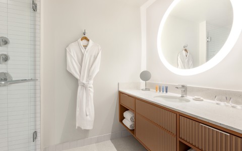 Bathroom with hanging robe and vanity mirror