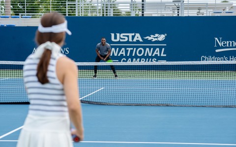 Two people playing tennis at USTA