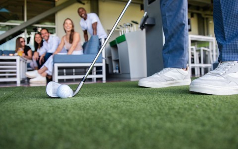 Close up of a person playing golf at InClubGolf