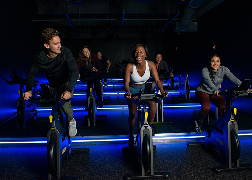 people cycling in a cycling studio