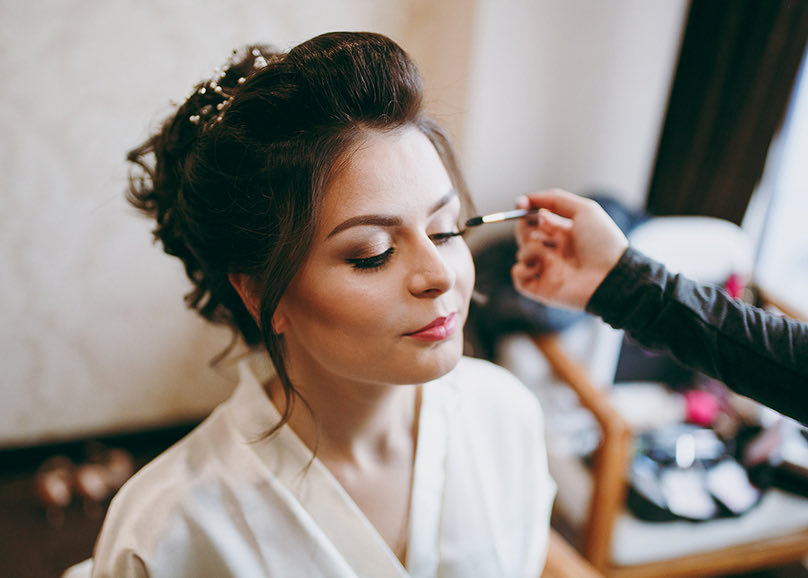 woman getting her make up done for her wedding
