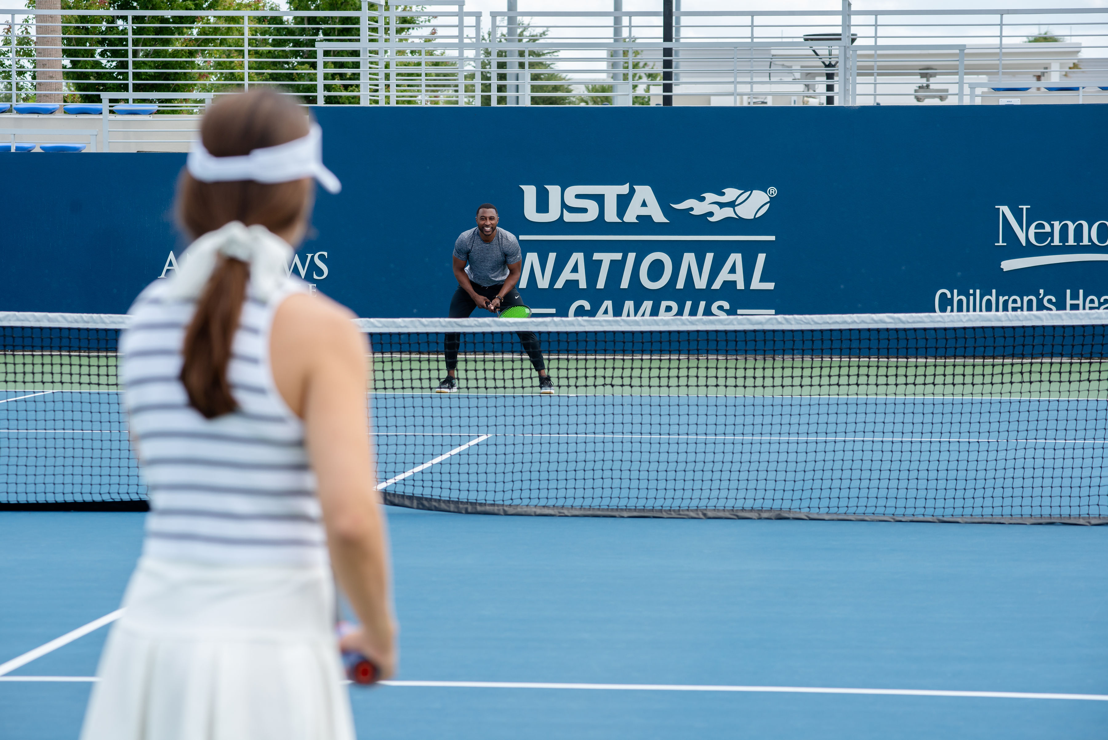 two people playing tennis at usta national campus
