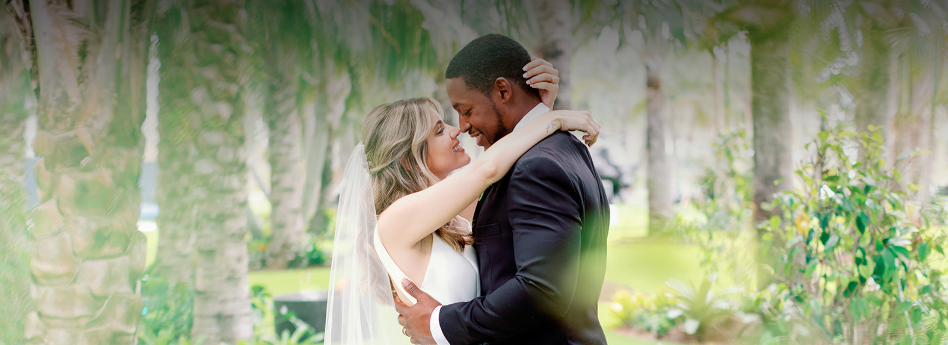 bride and groom outside surrounded by greenery