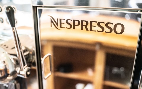 close up of nespresso logo on machine