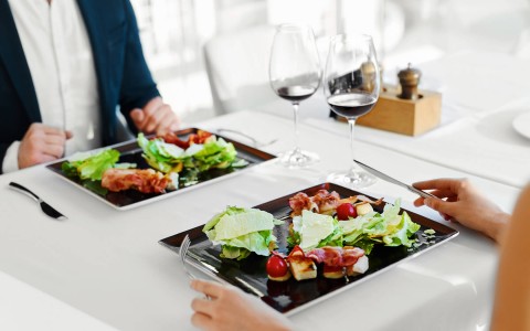 salad and other items on black plate