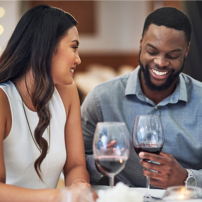 people laughing over a glass of wine