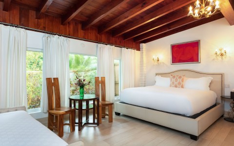 spacious room with king bed and wooden ceilings