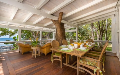 dining area in a covered patio with long rectangular table