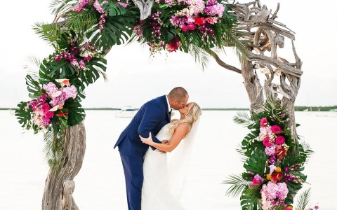 newlyweds kissing under their altar
