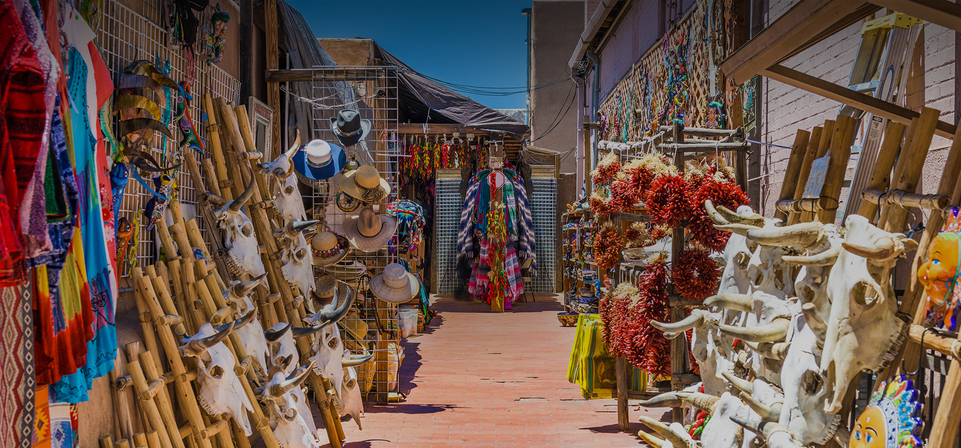 a bunch of artwork displayed outdoor in a market during the day