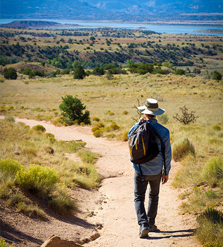 a man walking along a path outdoors during the day