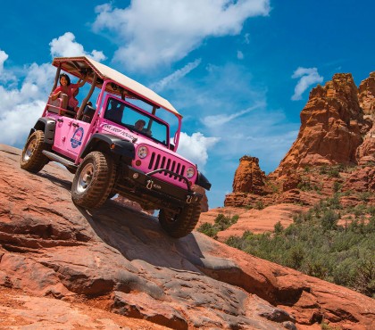 View of a pink jeep on a rocky road