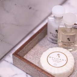 bvlgari shampoo and soap in a bathrooms cabinet 
