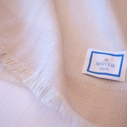 blanket with a matouk tag on it
