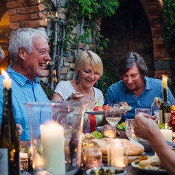 group of older people enjoying dinner outdoors