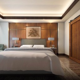 king bed within the suite that has wooden furniture and details