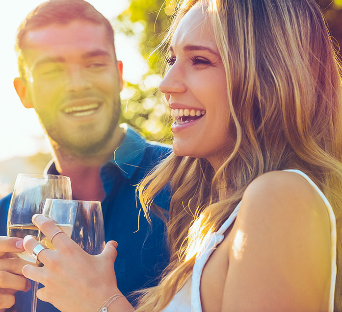 two people laughing enjoying wine