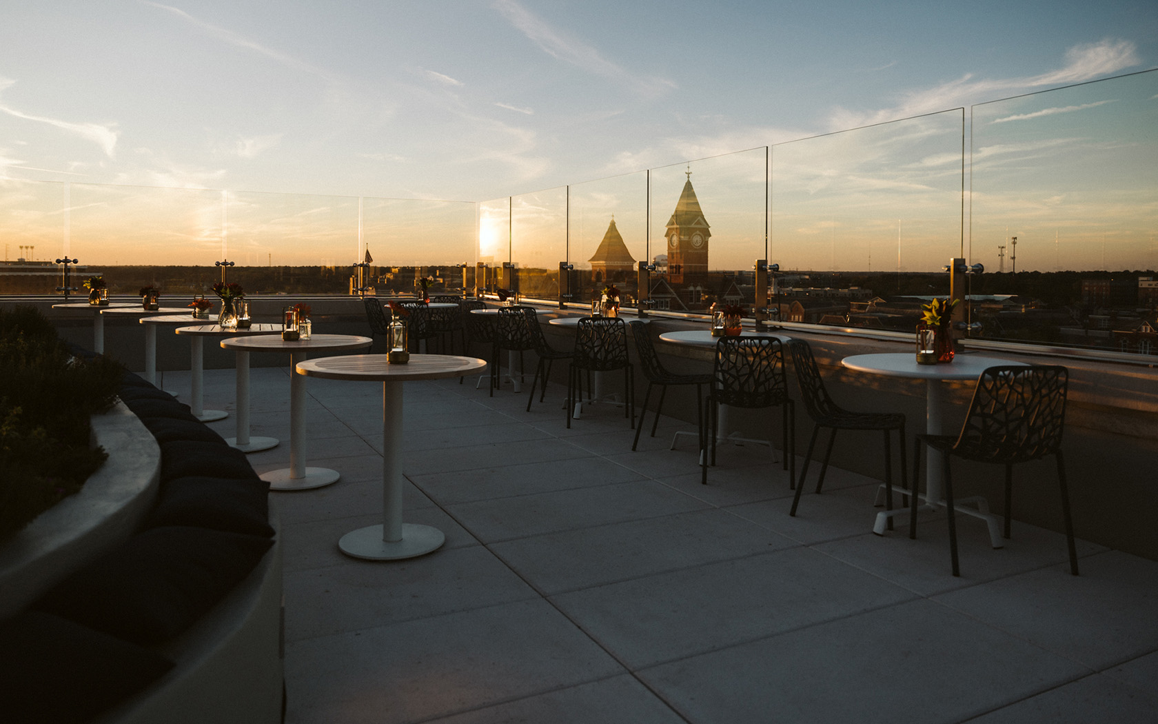 rooftop lounge tables overlooking the city at sunset