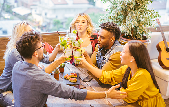 group of friends toasting with their mojitos
