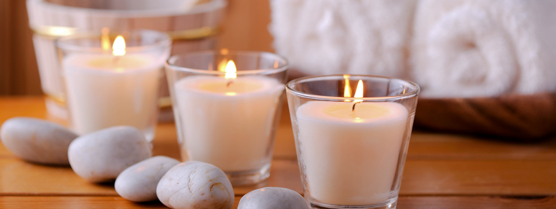 close up view of three lit candles on a table