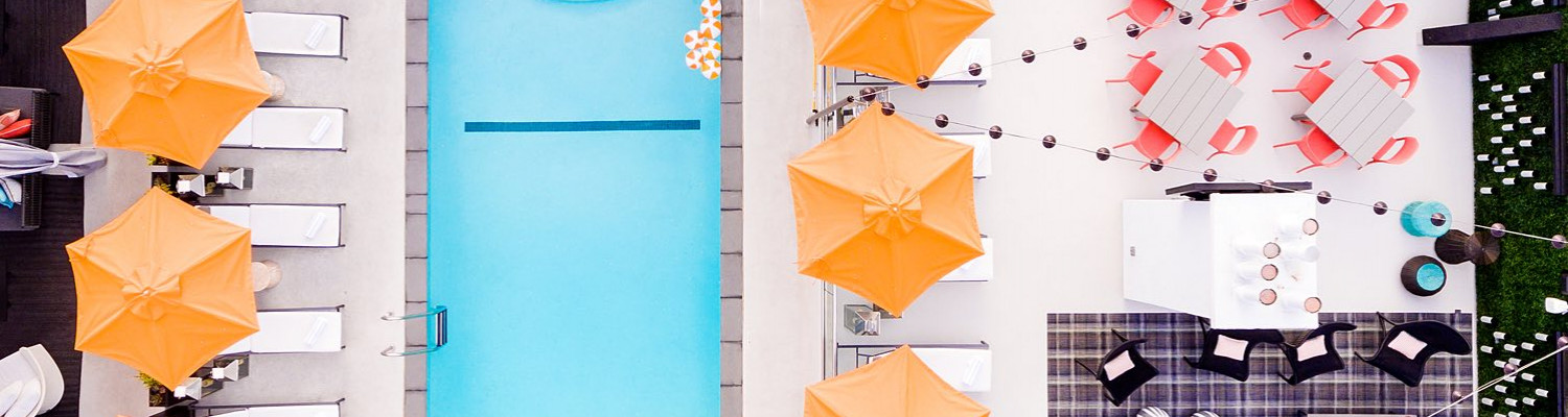 Overhead view of pool and open umbrellas 