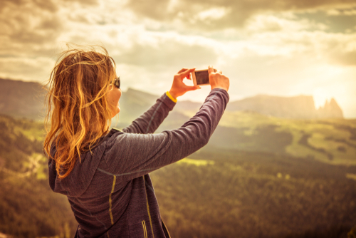 woman photographing the mountains