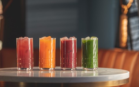 Four colorful juices on a table