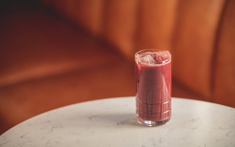Red smoothie drink on a marble table