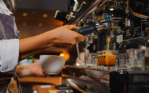 Close up of barista using espresso machine