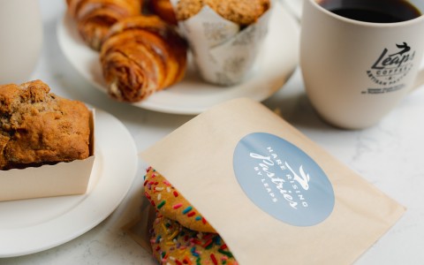 Close up of assorted pastries and a cup of coffee in a Leaps coffee mug