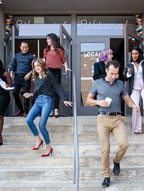 group of people walking down the stairs of the entry