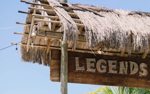legends tiki bar roof and sign on the beach