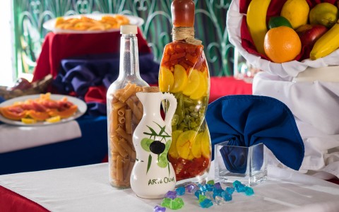 colorful bottles of vegetable and basket of fruit for dining tablescape