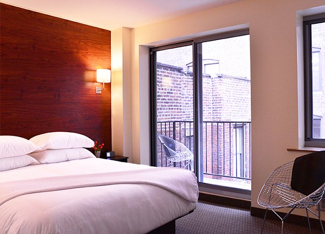guest room with a bed and balcony